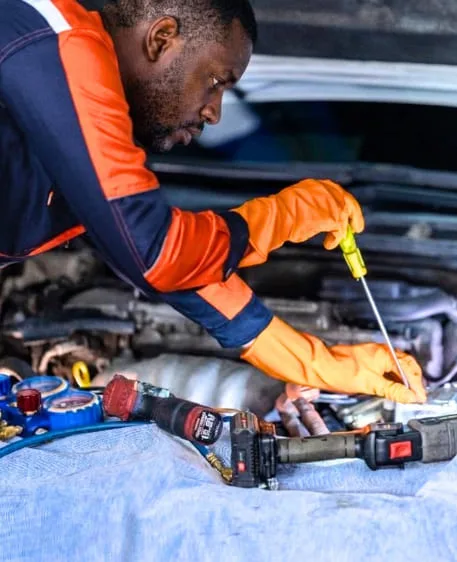 Arctic Wave AC Solutions technician servicing a vehicle AC system